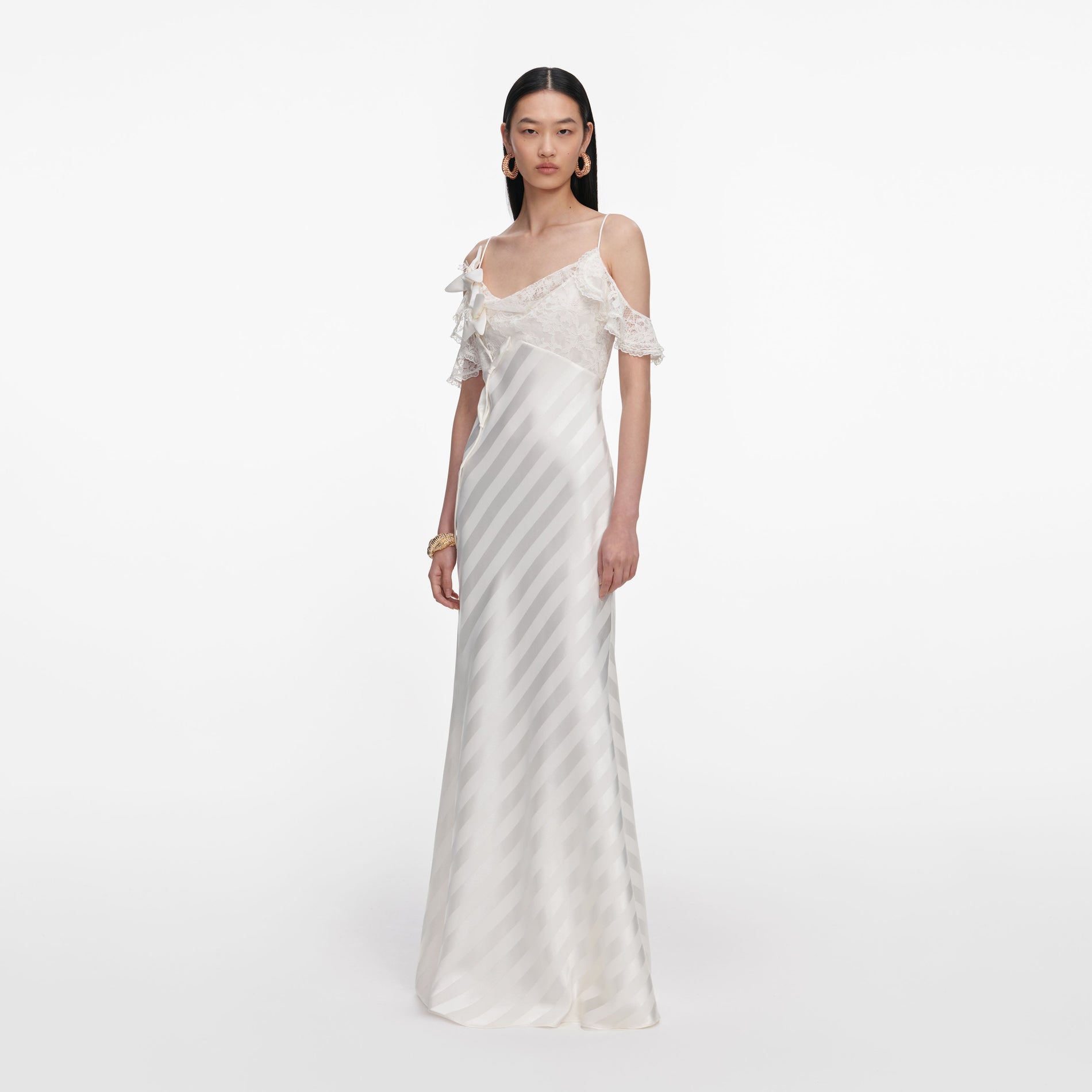 Side view of a woman wearing the Cream Satin Striped Maxi Dress