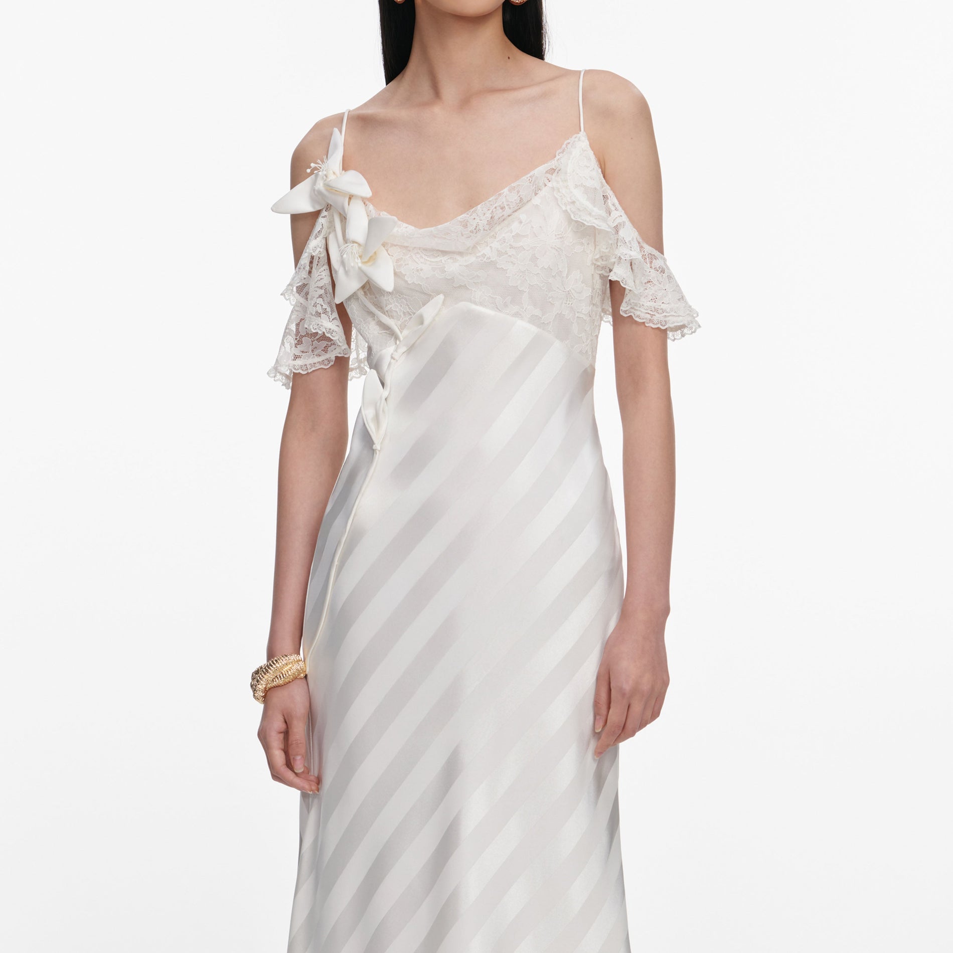 A close up of a woman wearing the Cream Satin Striped Maxi Dress