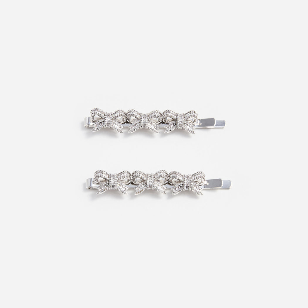 Two silver hair clips with three crystal-encrusted bows on each