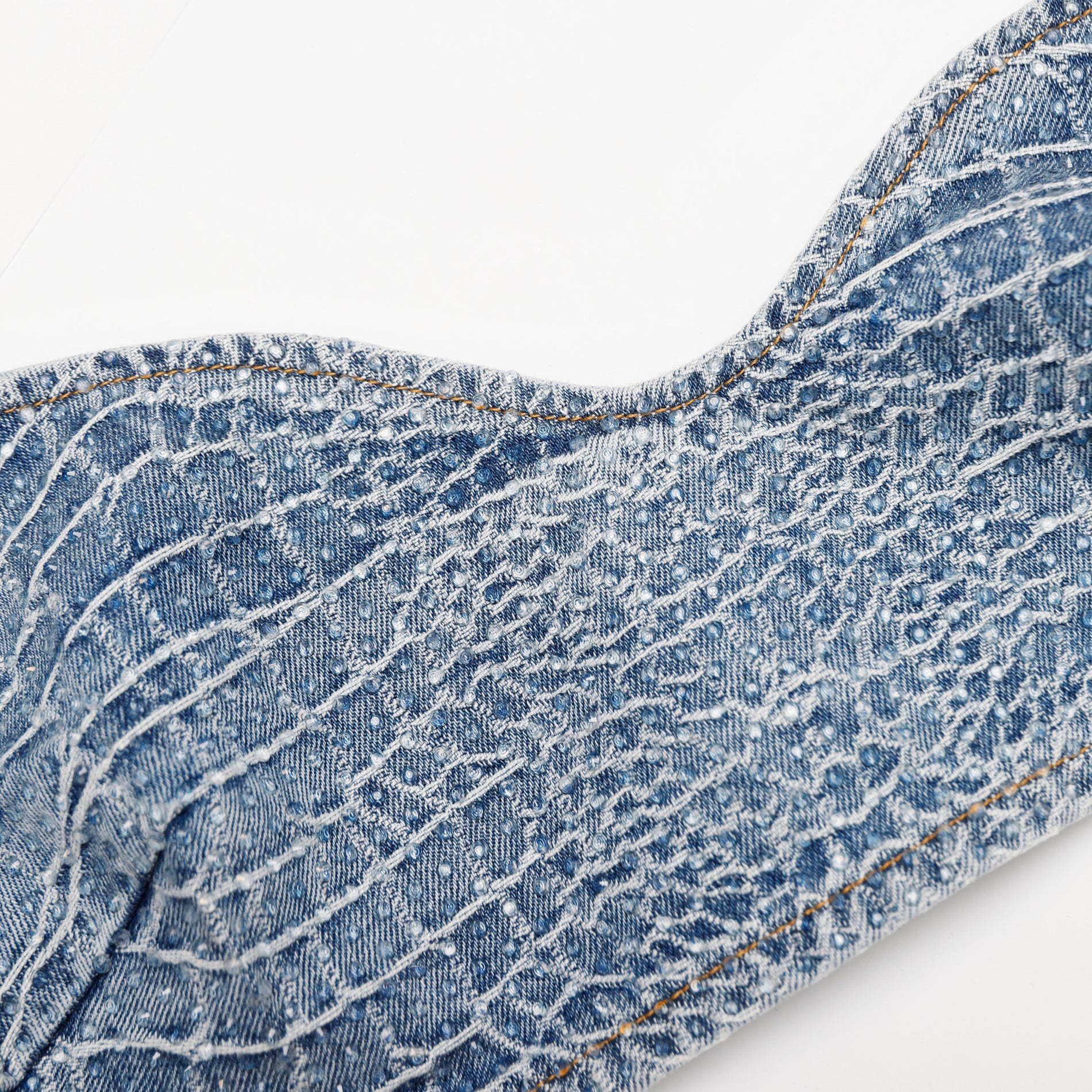 A close up of the fabric for the Rhinestone Croc Effect Denim Bralette