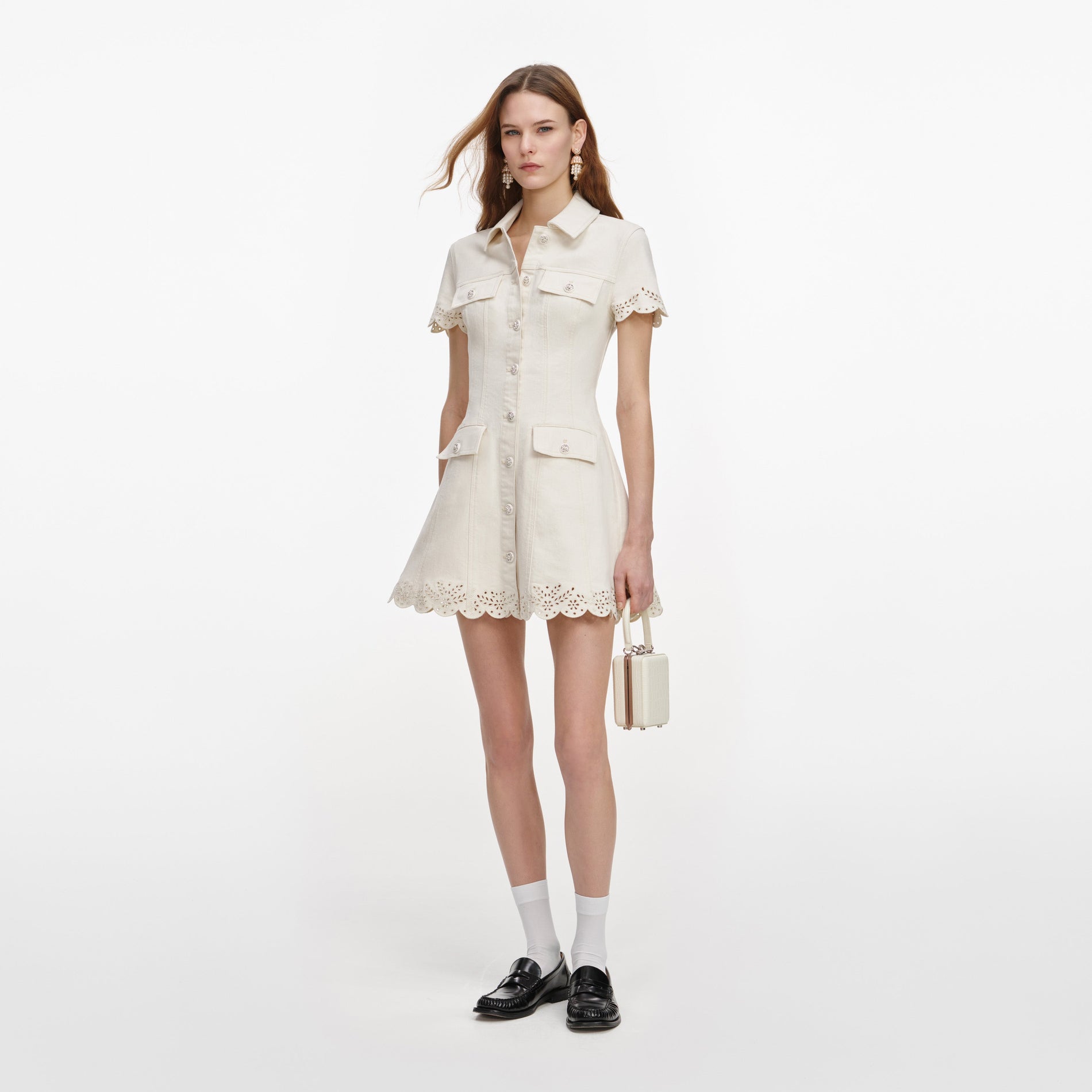 Side view of a woman wearing the Cream Broderie Denim Mini Dress