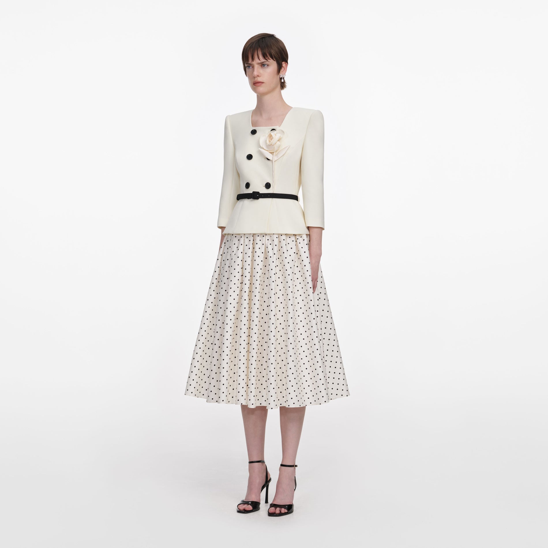 Side view of a woman wearing the Cream 3D Flower Polka Dot Midi Dress