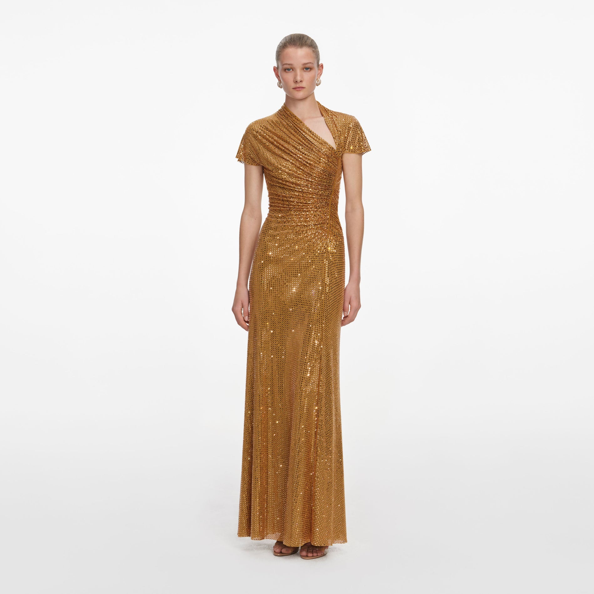 Front view of a woman wearing the Gold Rhinestone Drape Maxi Dress