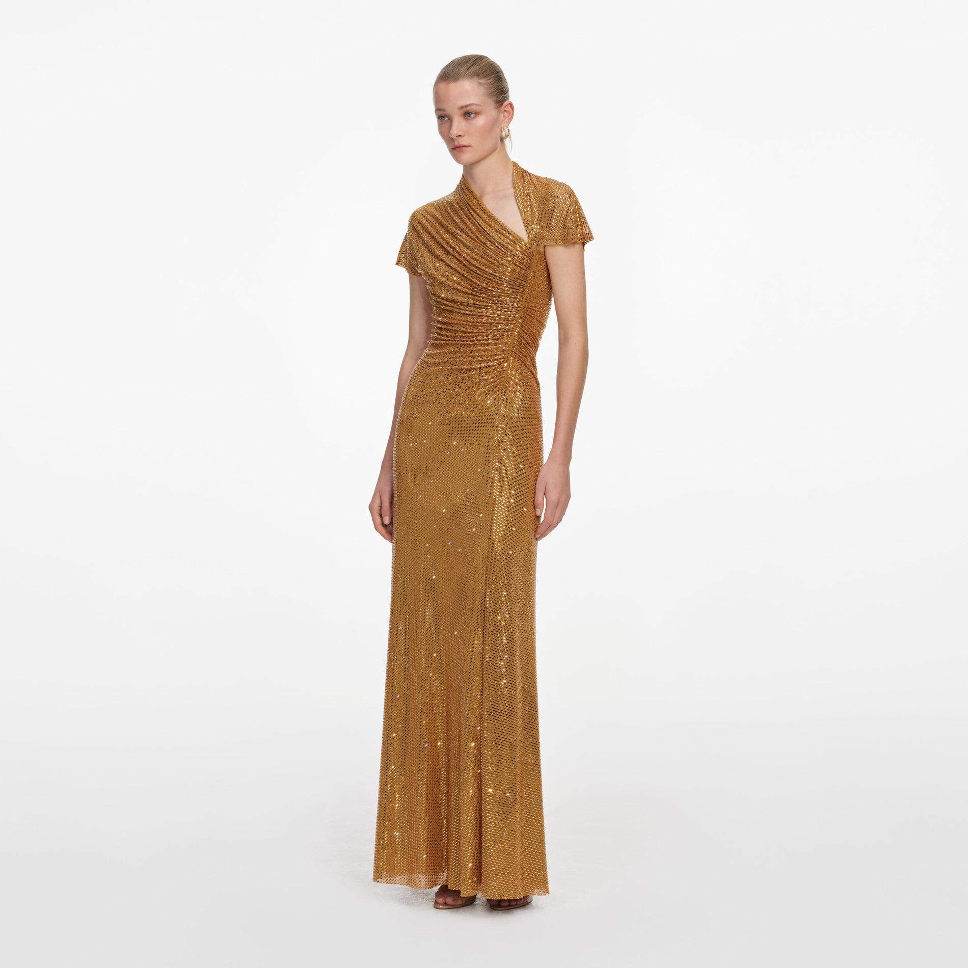 Side view of a woman wearing the Gold Rhinestone Drape Maxi Dress