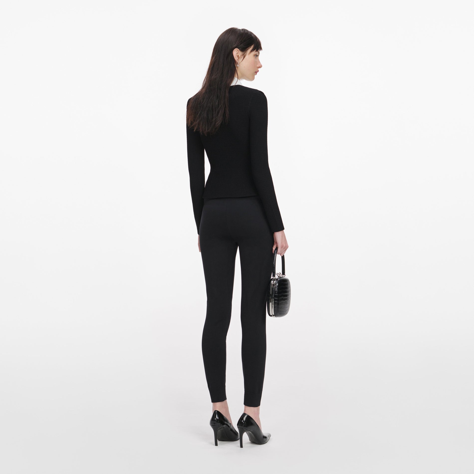 Back view of a woman wearing the Black Tailored Knit Top