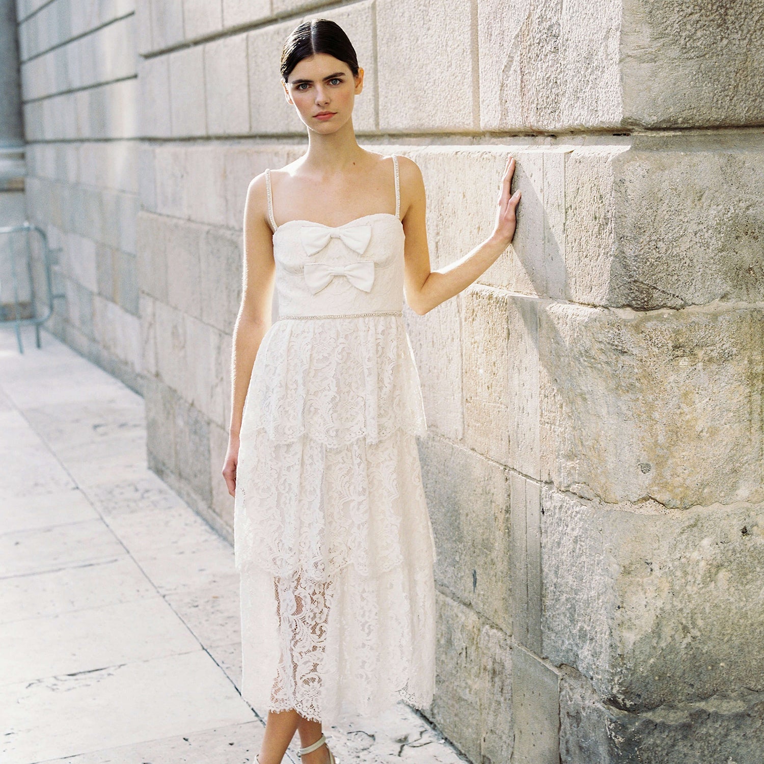 A woman wearing the Cream Cord Lace Tiered Midi Dress