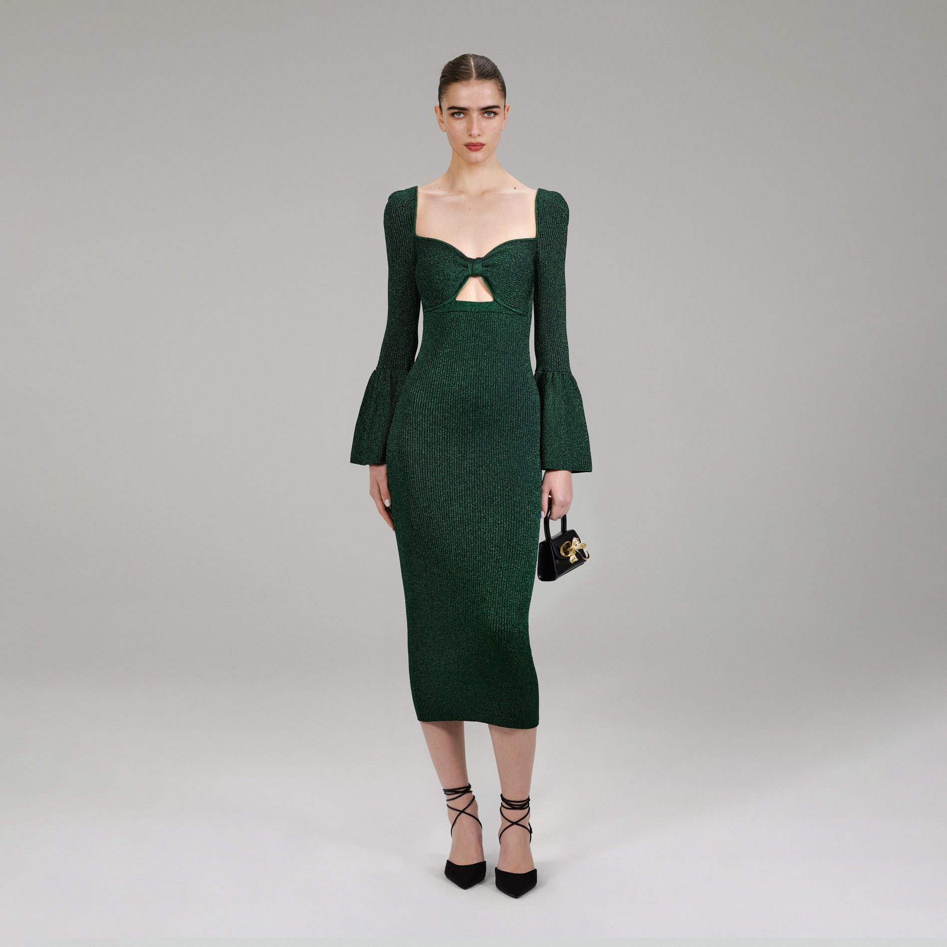 A woman wearing the Green Lurex Knit Midi Dress