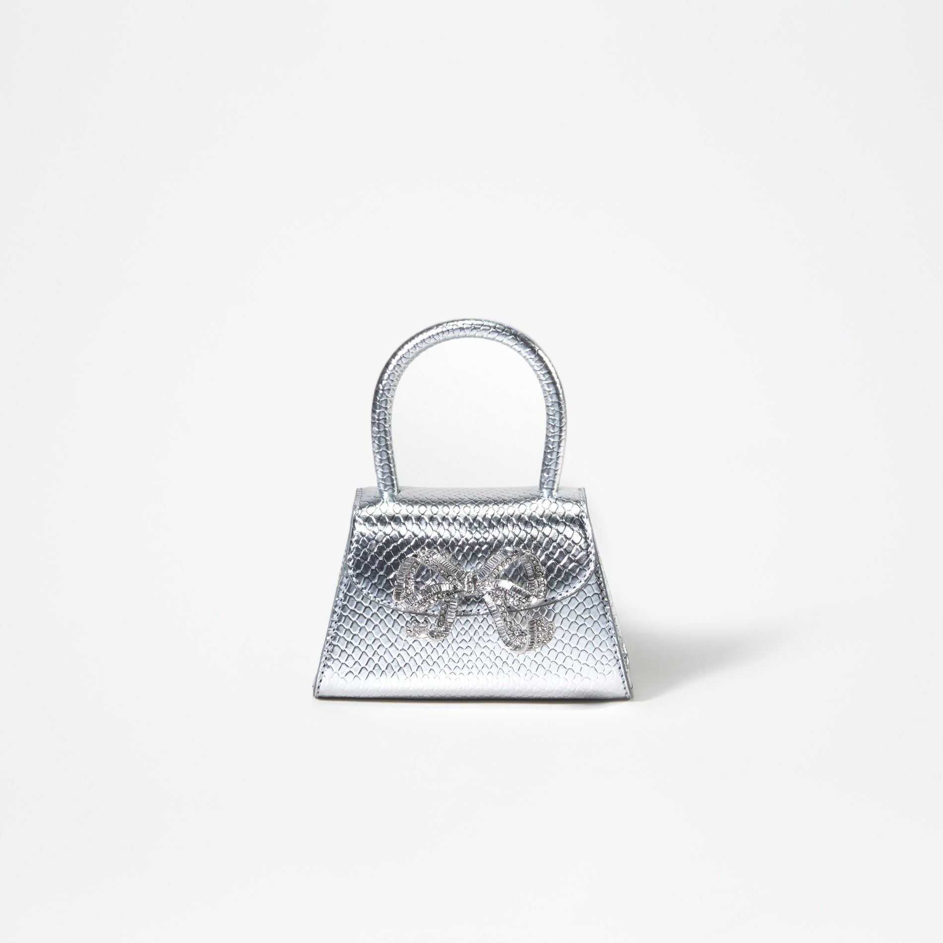 A woman wearing the Silver Python Diamante Bow Micro Bag