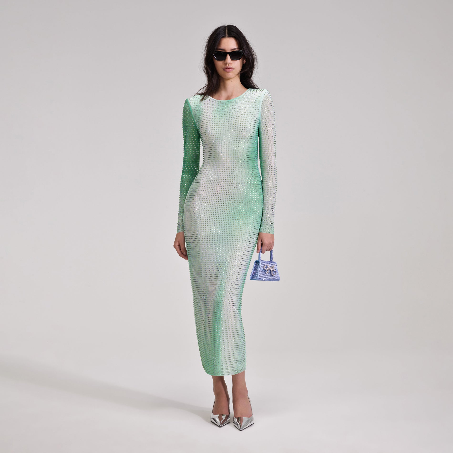 A woman wearing the Green Contour Print Midi Dress