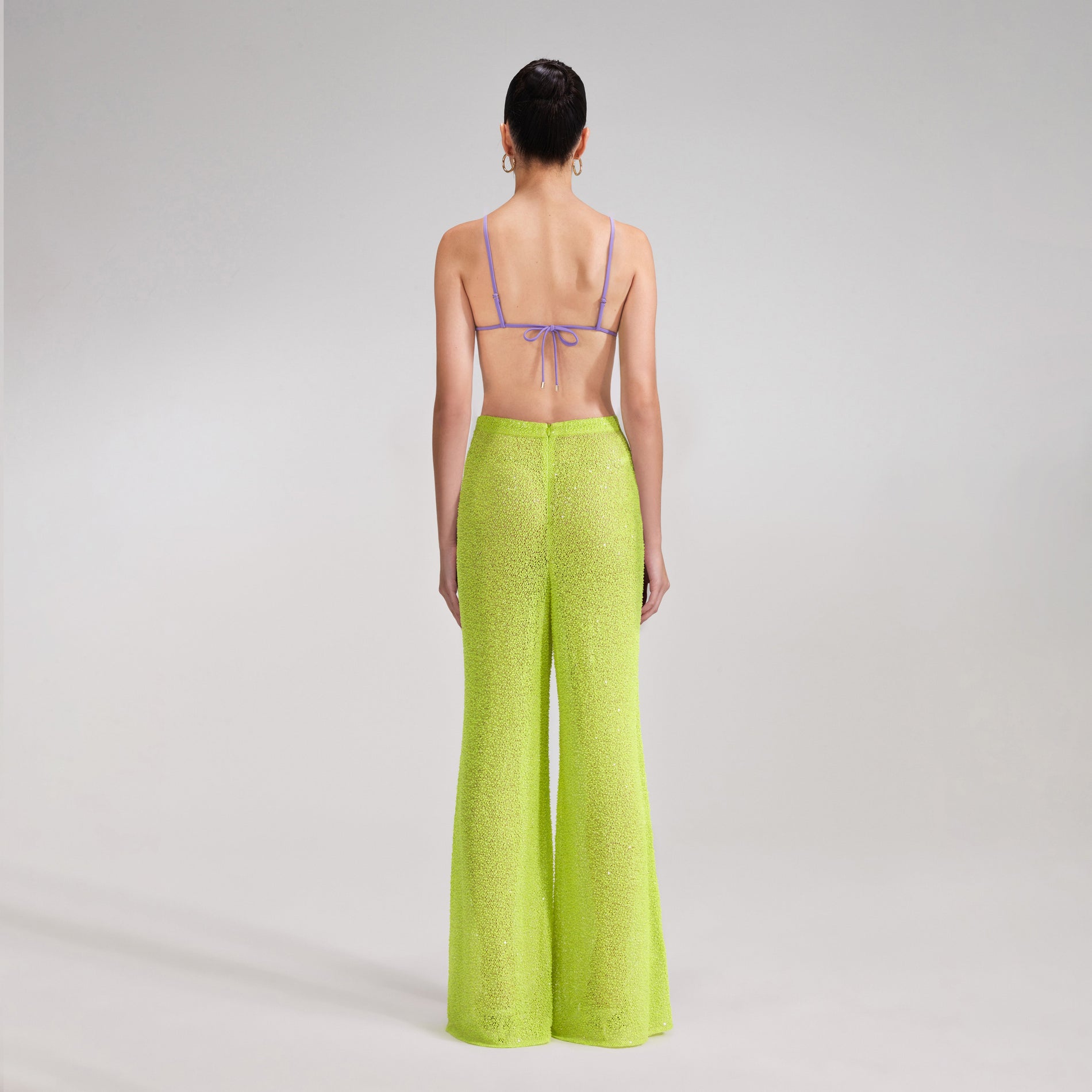 A woman wearing the Green Beaded Trousers