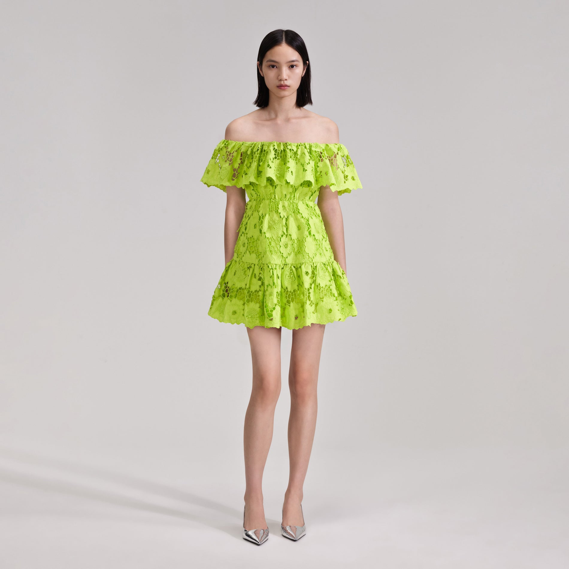 A woman wearing the Green Lace Off Shoulder Mini Dress