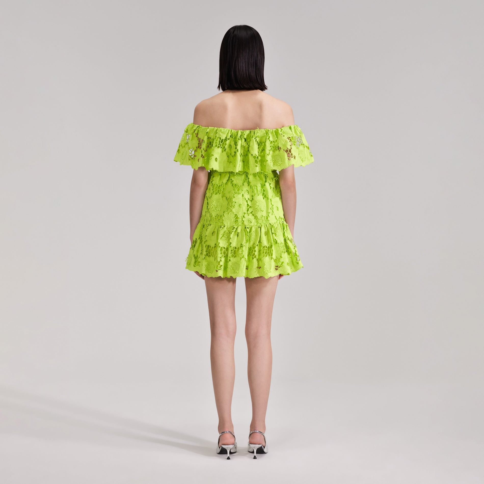 A woman wearing the Green Lace Off Shoulder Mini Dress
