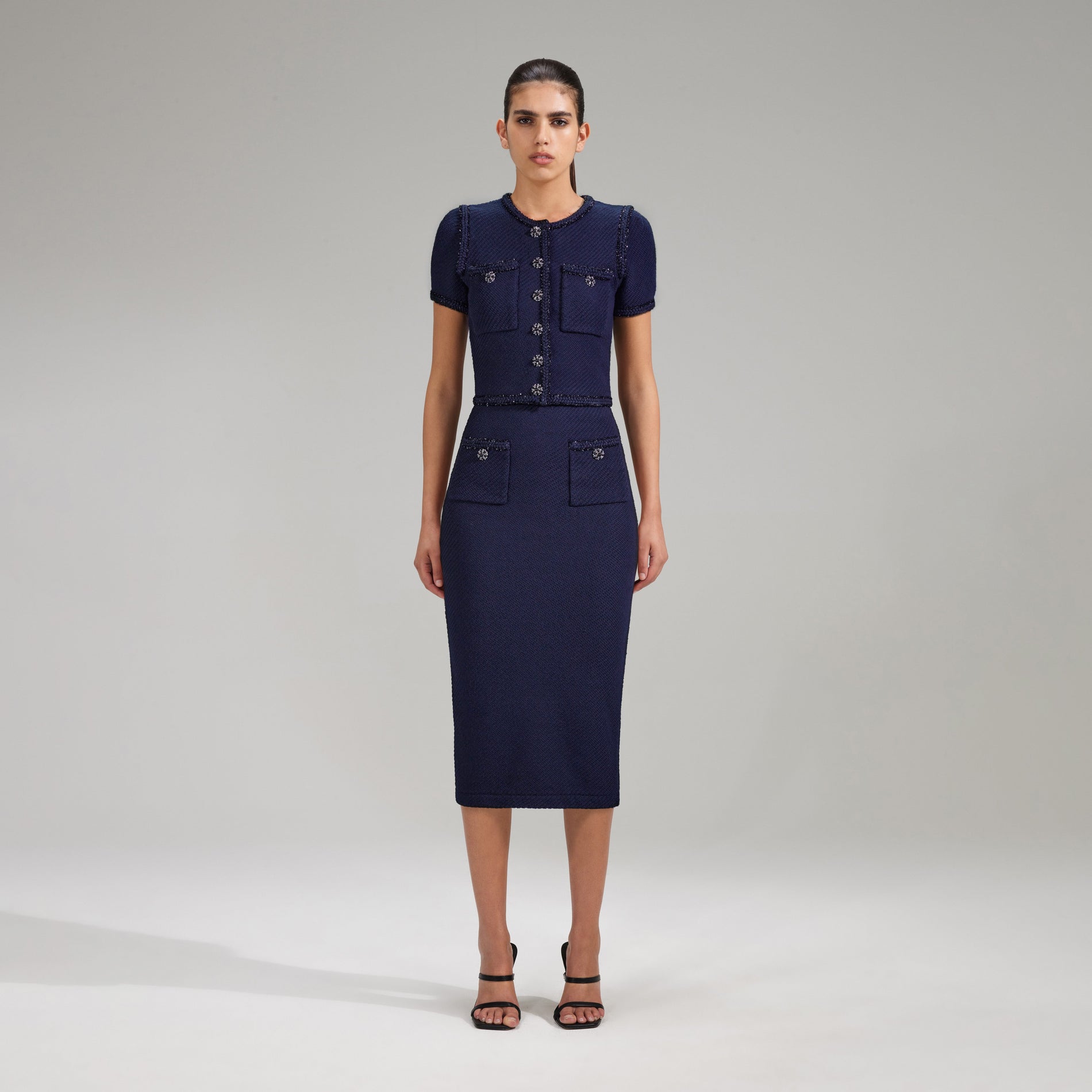 A woman wearing the Navy Knit Midi Skirt