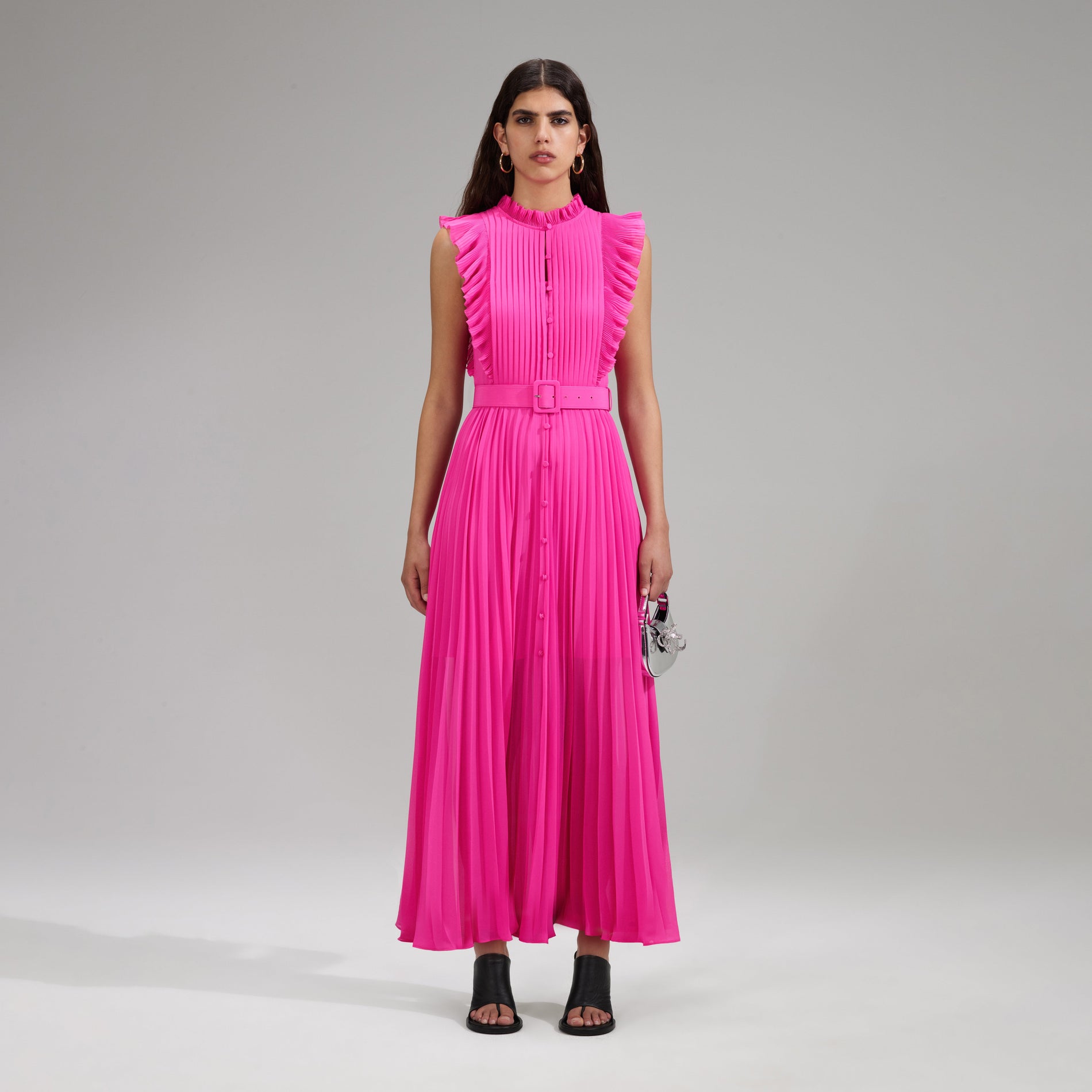 A woman wearing the Pink Chiffon Sleeveless Ruffle Midi Dress