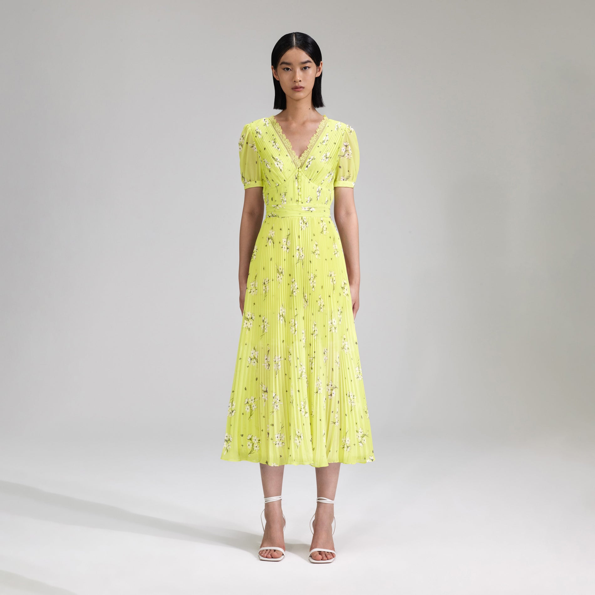 A woman wearing the Lime Floral Chiffon Midi Dress