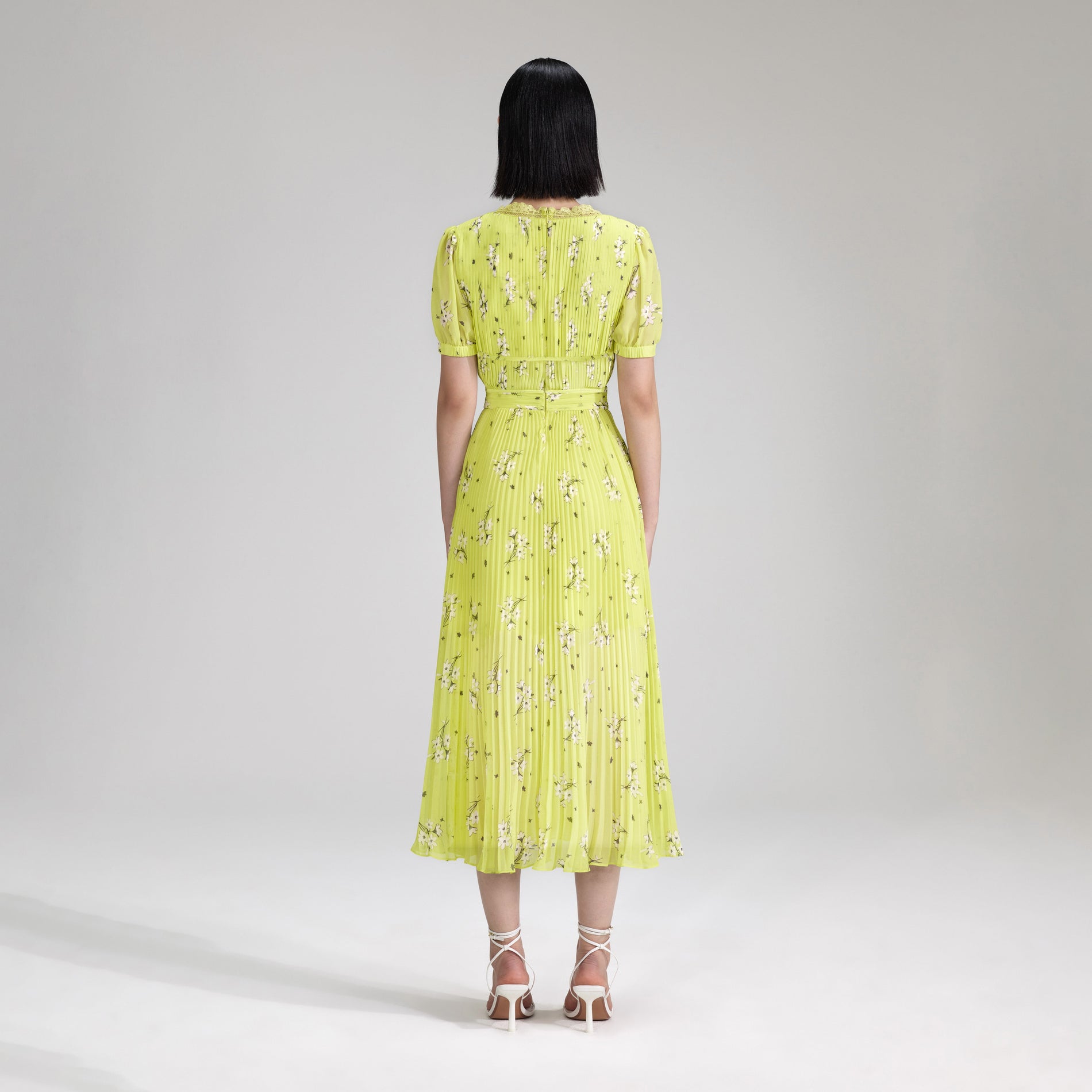 A woman wearing the Lime Floral Chiffon Midi Dress