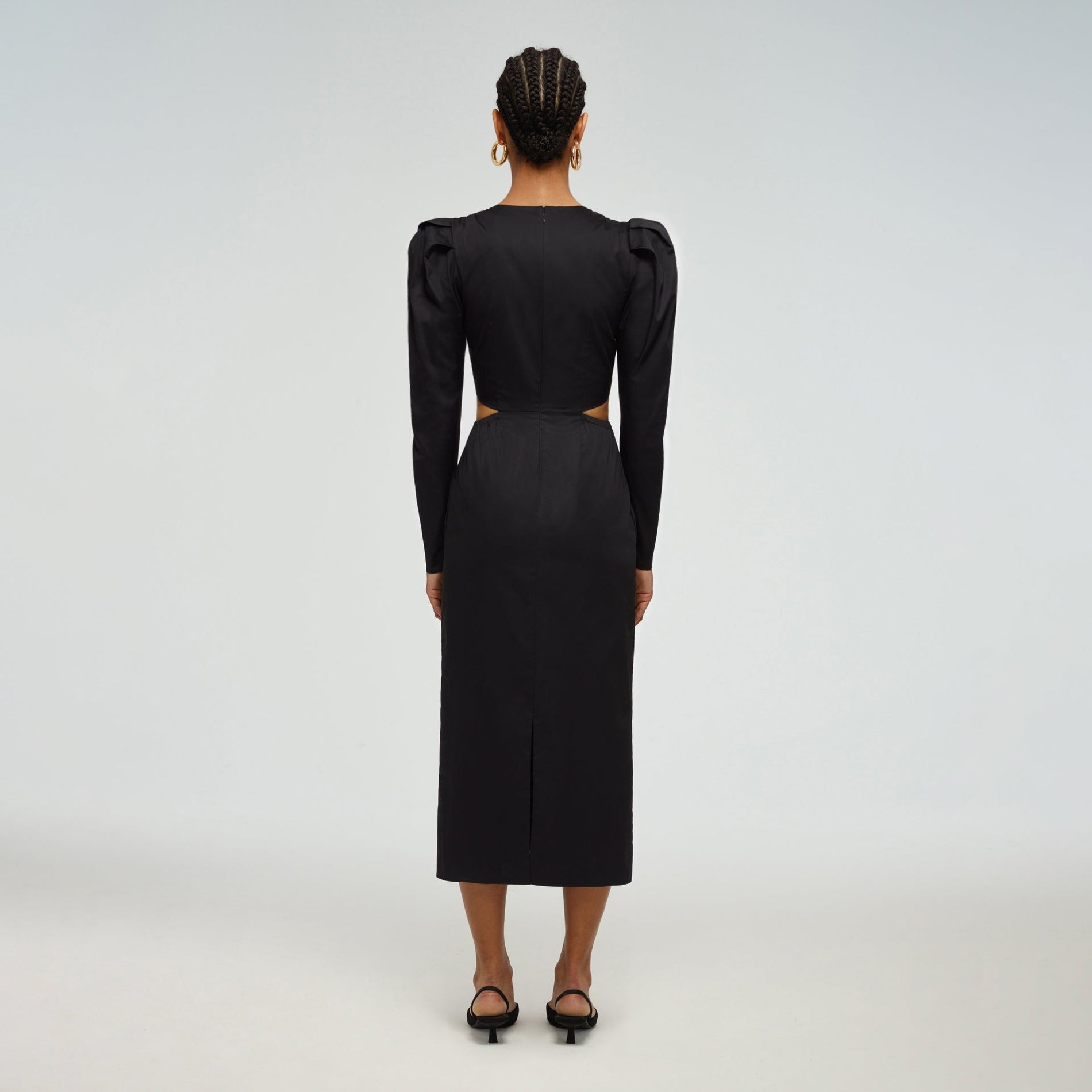 A woman wearing the Black Cotton Cut Out Midi Dress